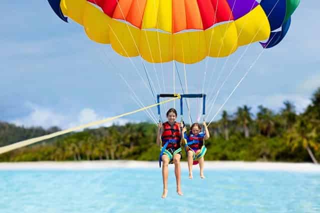 Brother and sister parasailing