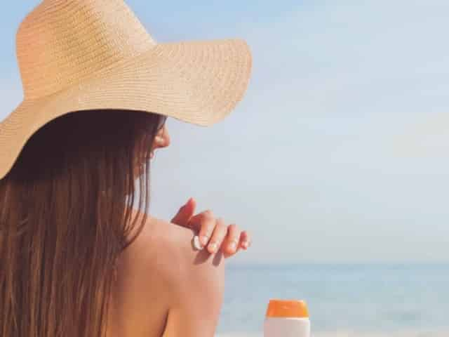 Woman applying sunscreen