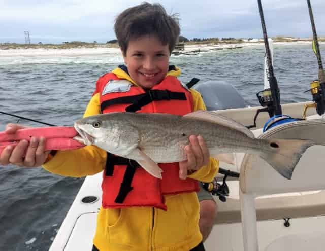 child catches redfish in destin florida