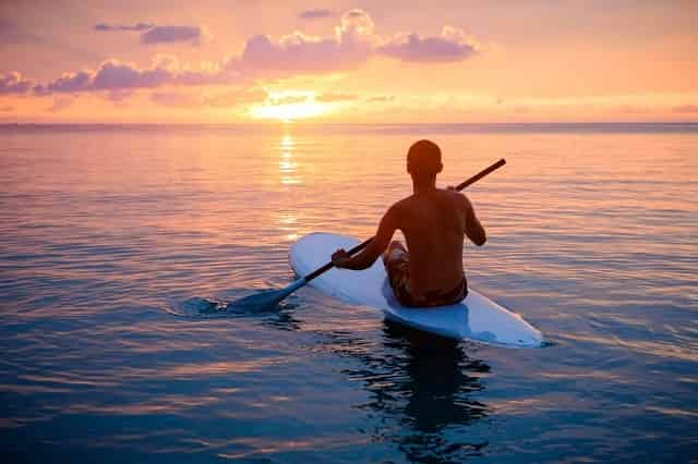 Man paddleboarding at sunset in Destin