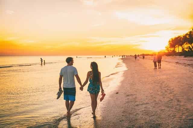 Couple walking on the beach at sunset in Destin