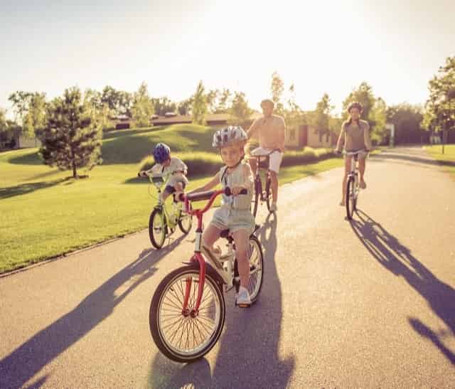 Family riding bikes around town