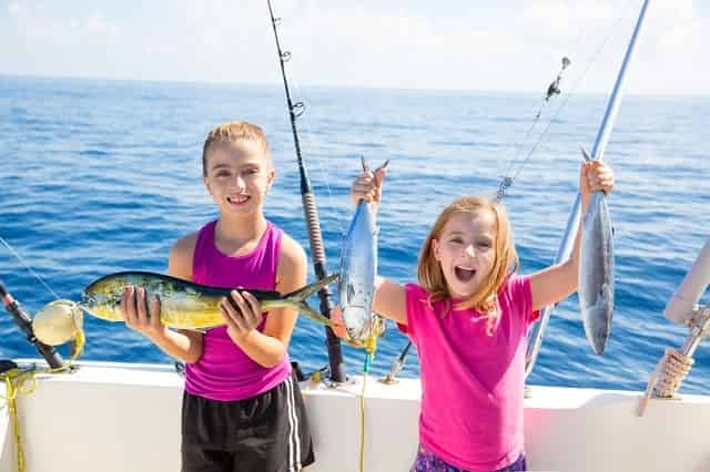 Two girls holding up their catch