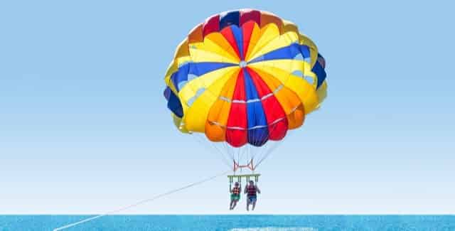 Couple parasailing on a beach