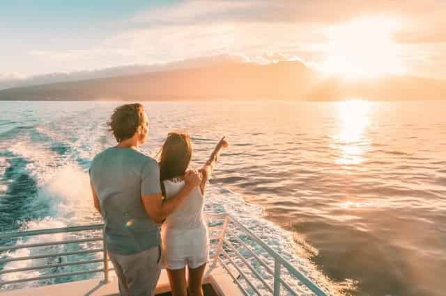 Couple watching a sunset on boat deck