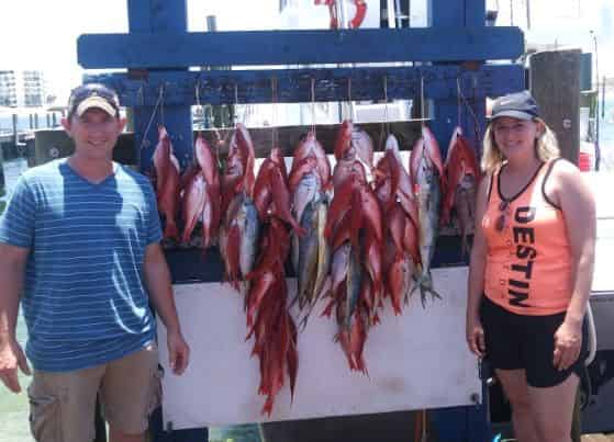 couples catches snapper on deep sea fishing trip