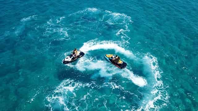 Jet skis moving through turquoise waters