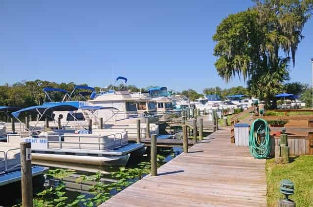 Pontoon boats docked at a marina