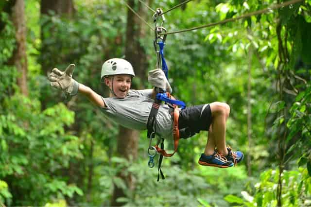 Boy ziplining at Zip'N Fun Adventure Park Top 10 Kid Friendly Activities in Gulfport, MS