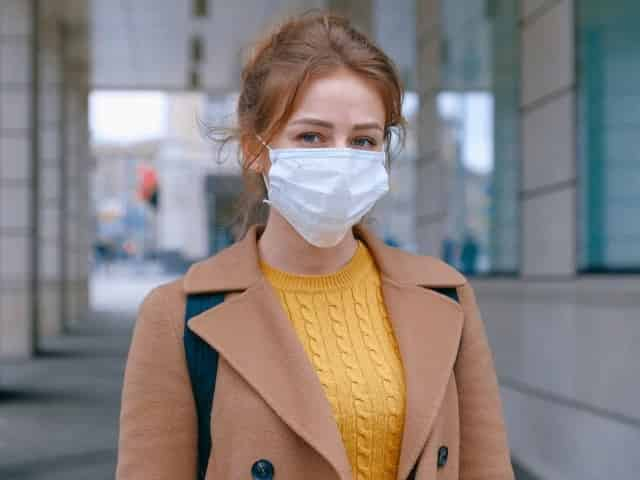 woman in face mask taking precautions against coronavirus