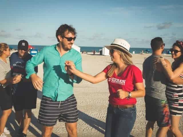 couples dancing on the beach during a city tour of Miami