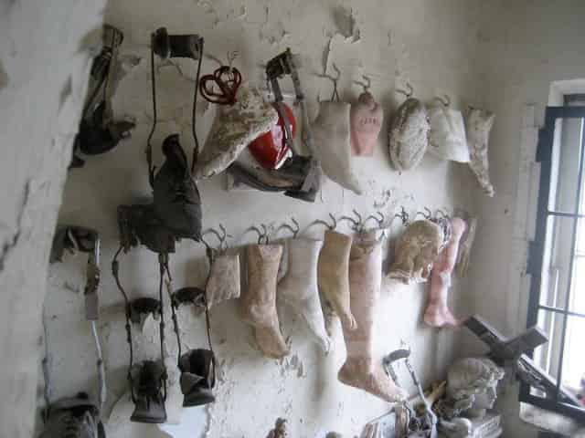 doll legs and feet on walls of st roch chapel