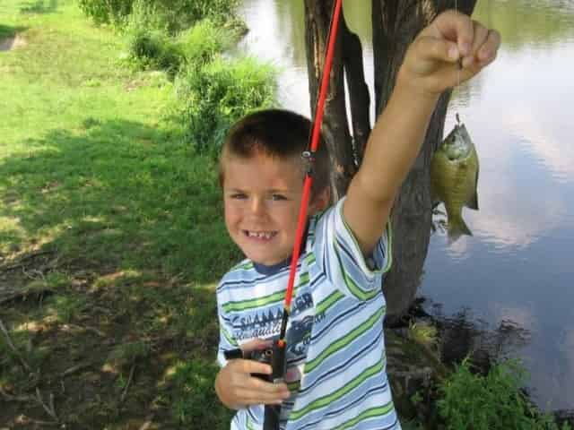 boy proudly shows off catch