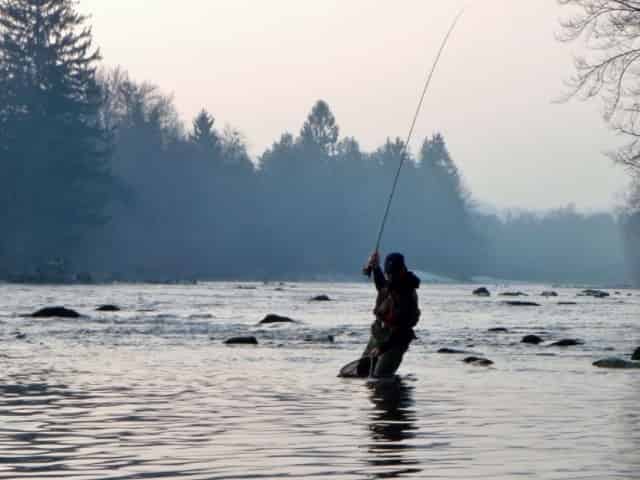 angler freshwater fishing in the winter